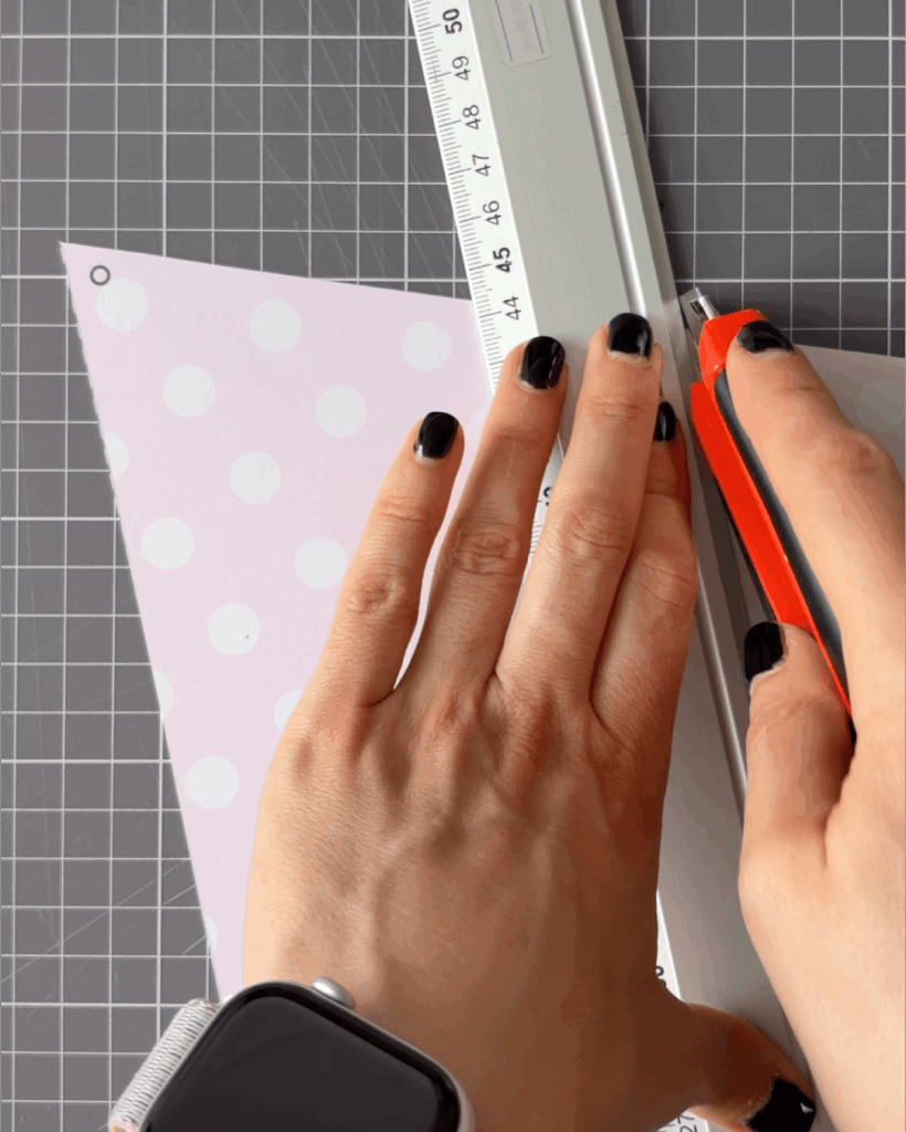 Carefully cut out each triangle flag using scissors or a craft knife.