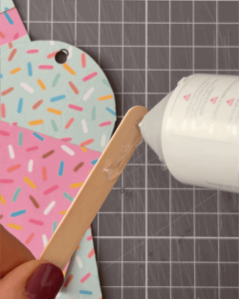 Glue a popsicle stick to the back of each one.