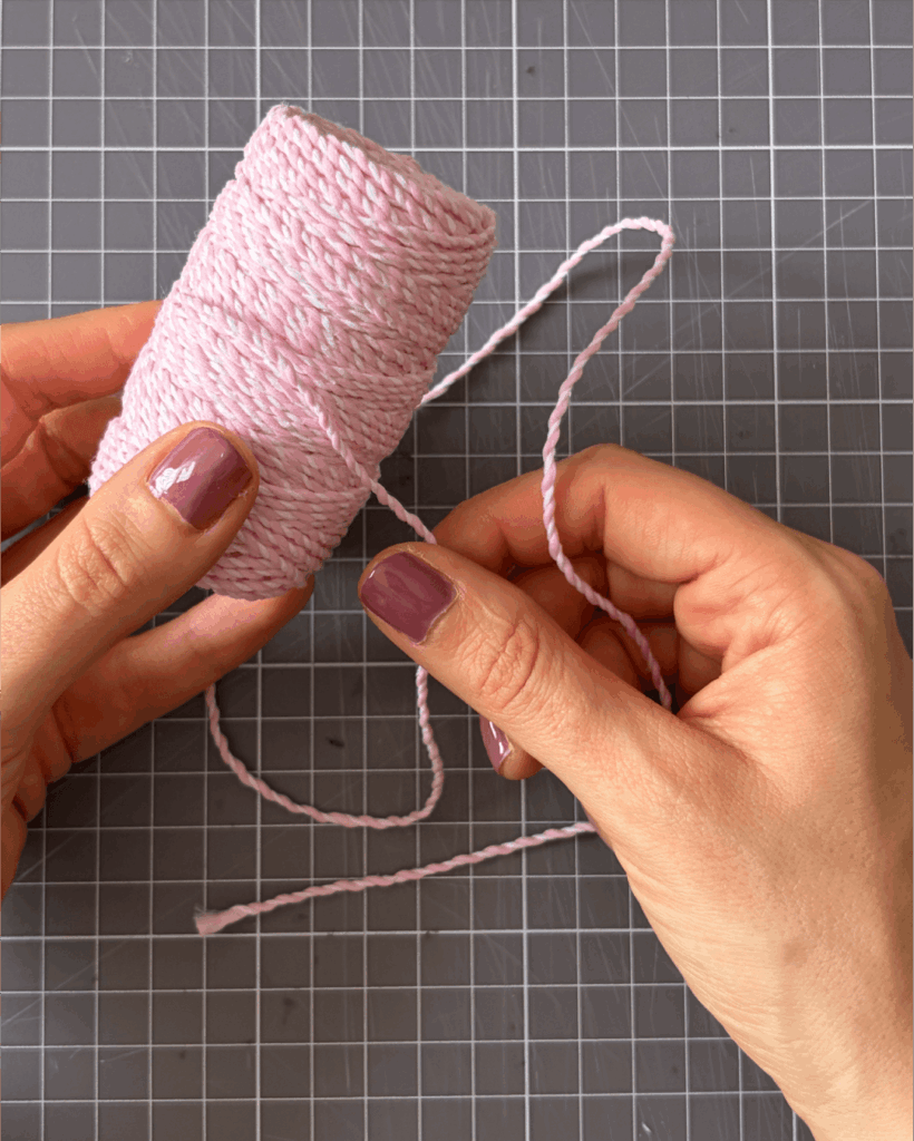 Thread baker's twine, string or ribbon through the holes.
